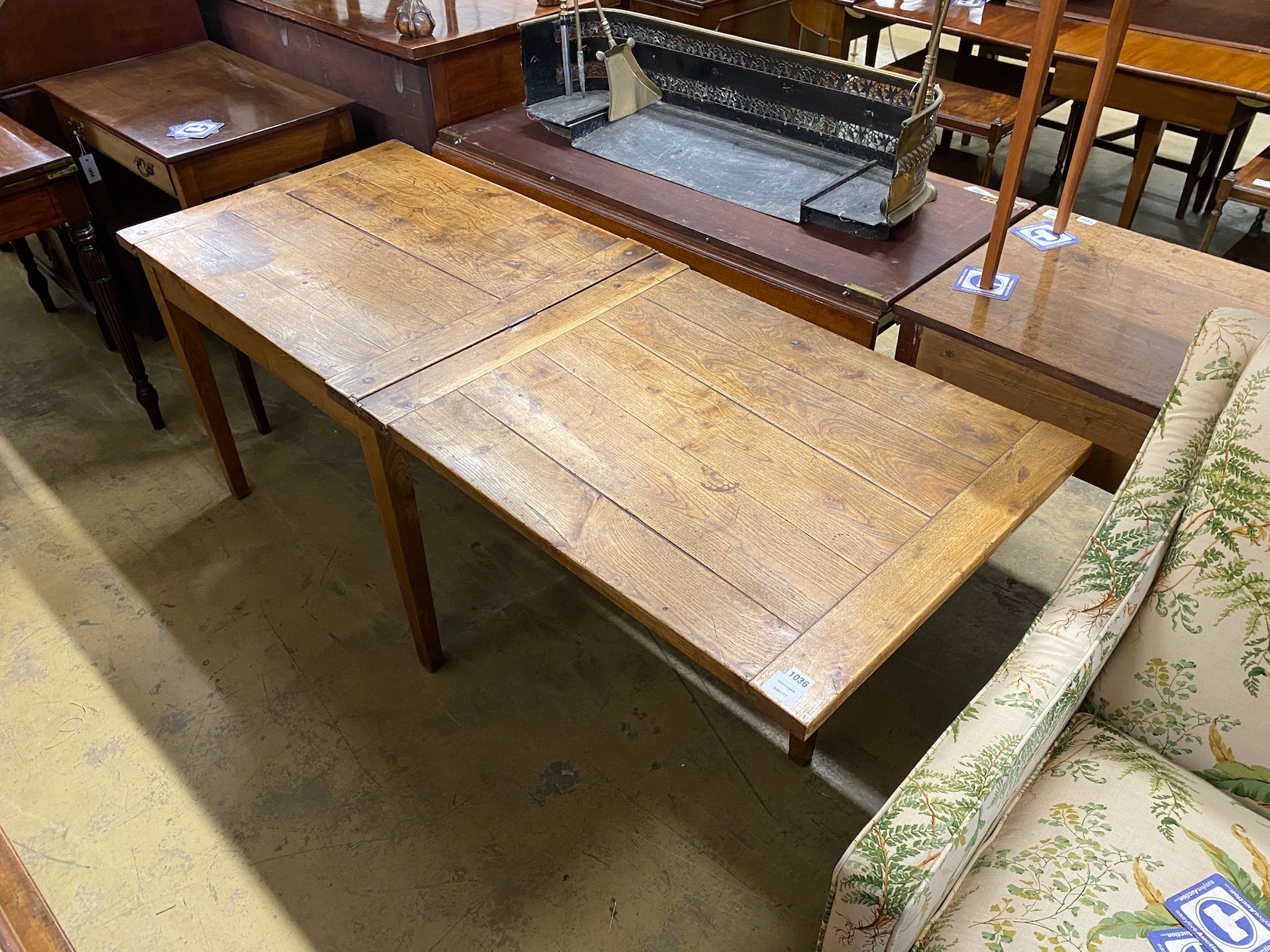 A 19th century French provincial oak farmhouse table with rectangular folding top on square tapered legs, 176cm extended, depth 69cm, height 74cm